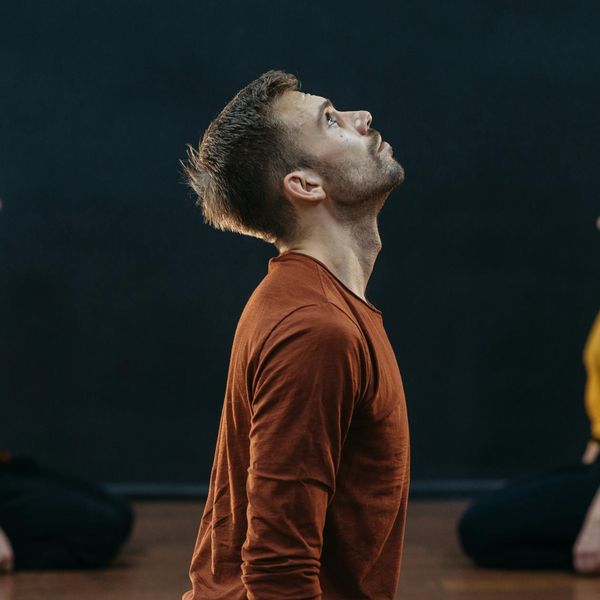 Man in a state of deep focus during a difficult balancing exercise.